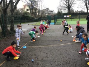 Year 1 children taking part in an outdoor PE lesson